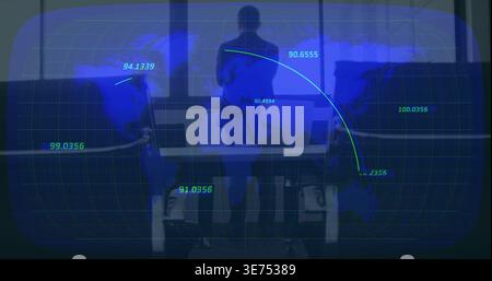 Standing adult Chinese man wearing business-casual, analyzing HUD map in control room with laptops. Silhouette, executive, collaboration, meeting, fut Stock Photo