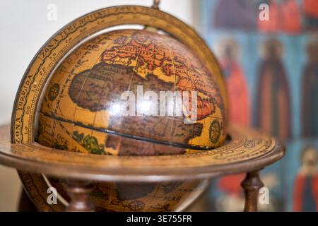 Close-up of a vintage-style terrestrial globe with antique cartography showing Europe, Africa, and parts of Asia including Arabia. The globe features Stock Photo