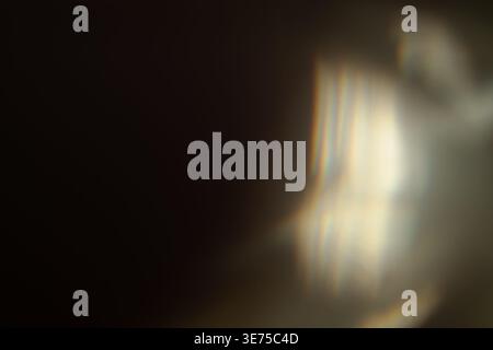 Dark cinematic background with warm prism light leak and dramatic shadows Stock Photo