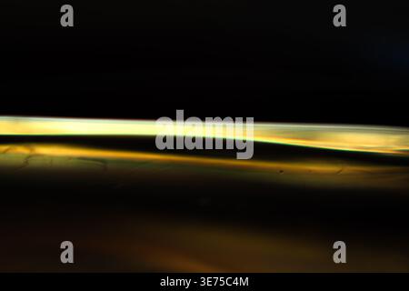High contrast golden light streak on black background for luxury branding Stock Photo