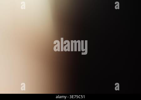 Dark moody brown background with soft warm light illumination on the side Stock Photo