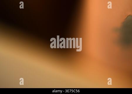 Warm tan abstract background with soft shadows and dark textural elements Stock Photo