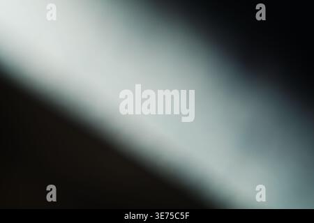 Cinematic light leak effect with diagonal white beam on dark background Stock Photo