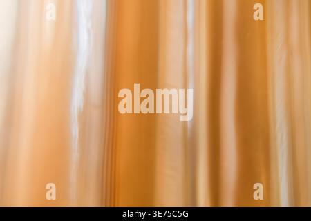 Abstract vertical stripes of warm beige and tan light in soft motion blur Stock Photo