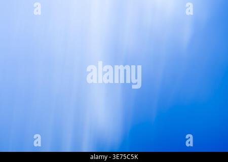 Soft ethereal blue and white abstract gradient background with subtle light rays Stock Photo