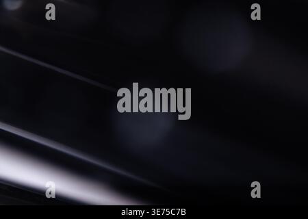 Abstract macro shot of dark metallic surface with diagonal lines and reflections Stock Photo