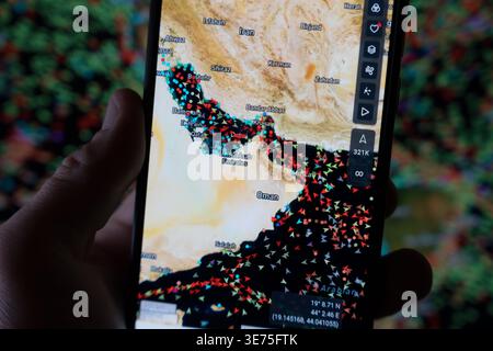 Strait of Hormuz maritime crisis dashboard on a smartphone showing real-time vessel density and restricted shipping corridors during the 2026 Iran-US Stock Photo
