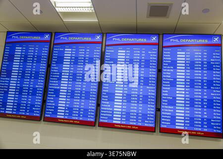 Philadelphia Pennsylvania,Philadelphia International Airport PHL,inside interior,terminal concourse gate area,departure boards PHL departures flight i Stock Photo