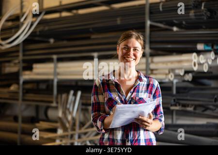 Joyful woman inspecting warehouse Stock Photo
