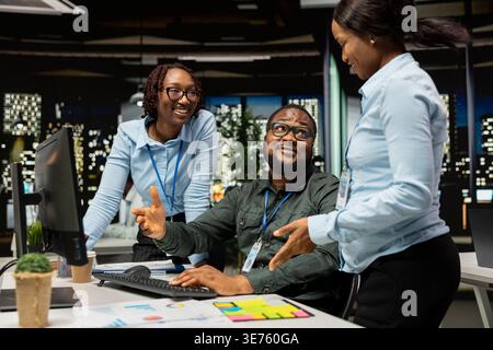 Business associates collaborating on a project with data insights and financial forecasting, projecting vision to expand the enterprise activity. Teamwork in workspace to ensure goals. Stock Photo