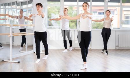 Female ballet dancer participating group rehearsal in studio Stock Photo