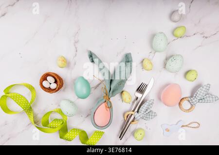 Minimalist Easter Flat Lay with Bunny Decor and Green Accents Stock Photo