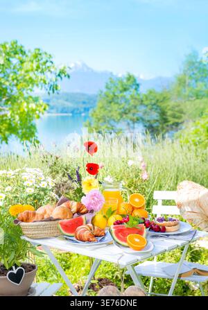 Breakfast for two, served on a table in a colorful garden blooming with coneflowers and hearts, Composing Stock Photo