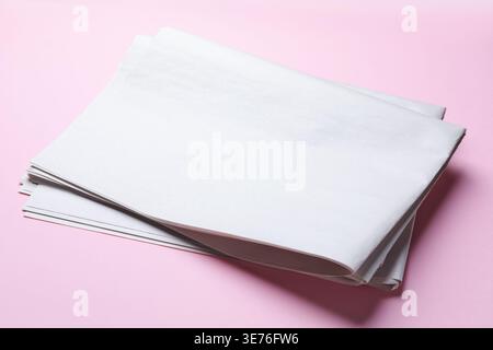 Newspapers on pink background, closeup. Mockup for design Stock Photo