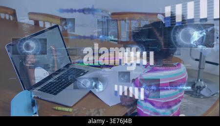 Working child in striped shirt doing homework at wooden dining table, with laptop and HUD Stock Photo