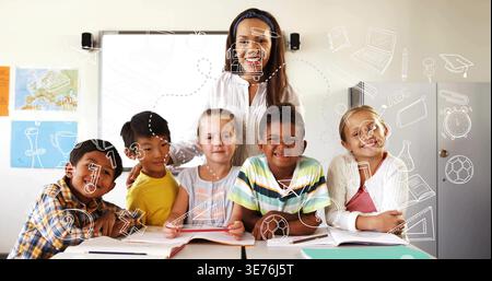 Smiling teacher wearing white top guiding five kids writing in class with notebooks tablet doodles Stock Photo
