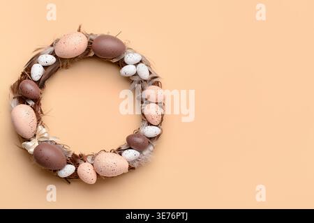 Easter wreath made of eggs and feathers on beige background Stock Photo