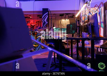 Ransomware on computer screen stealing privacy information in abandoned warehouse at night. Malicious software on monitors cracking password and breaching data in room with nobody Stock Photo
