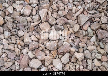 Texture of crushed stone and gravel, natural brown and grey rock fragments background for education and design Stock Photo