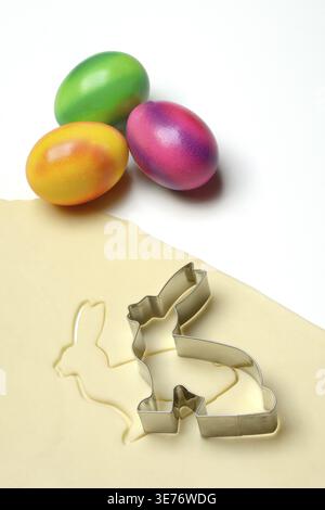 Rolled dough with bunny cookie cutter and easter eggs Stock Photo