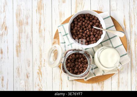 Quick breakfast for kids: chocolate corn balls with milk. Dry breakfast. healthy breakfast with cereal flakes. chocolate corn balls cereal and milk, m Stock Photo