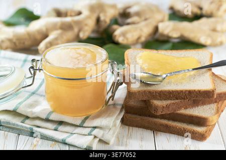 A stack of toasts with ginger jam on a dish close-up. Plate with pieces of toasted bread and tasty ginger jam Stock Photo
