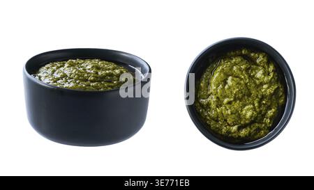 Black ceramic bowl of basil sauce pesto isolated on white background, top view Stock Photo