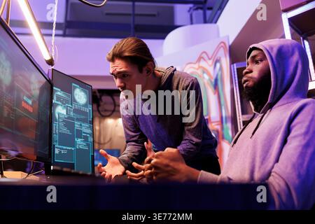 Frustrated criminals failing while attempting to crack strong password. Scammers breaking into network system unsuccessfully looking at screen displaying access denied message Stock Photo