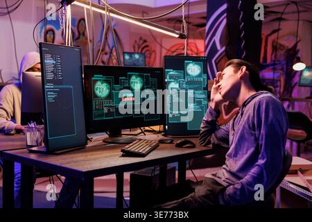 Unhappy hacker failing to pass server security system illegally. Young asian criminal getting access denied message on computer while hacking database server unsuccessfully Stock Photo