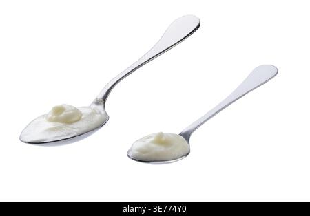 Probiotic yogurt in a metal spoon isolated on a white background Stock Photo