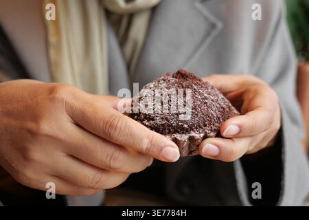 Enjoying a sweet treat in a cozy setting Stock Photo