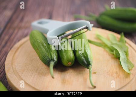 Cutting cucumbers on a wooden board Stock Photo