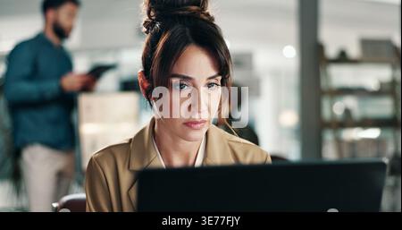 Woman, designer and night with laptop in office for project deadline, tight schedule or tasks. Female person, web design or working late with computer Stock Photo