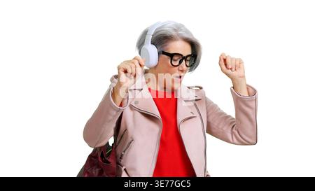 Energetic mature woman enjoying music and dancing Stock Photo