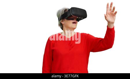 Senior woman experiencing virtual reality technology on white background Stock Photo