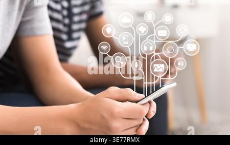 Young man using smartphone with virtual icons Stock Photo