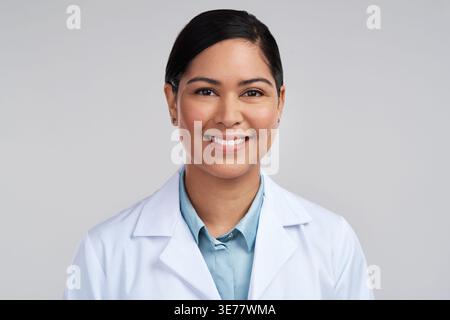 Portrait, scientist and woman with smile in studio, professional and confident for medical innovation. Happy, healthcare and lab technician with pride Stock Photo