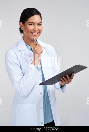 Woman, clipboard or scientist thinking in studio for clinical trial, problem solving or medical study. Checklist, research intern or portrait on white Stock Photo
