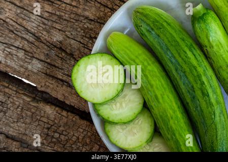 Fresh cucumber. fresh cucumber slices on wooden background, cucumber slices close up Stock Photo
