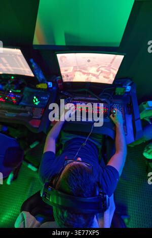 Overhead View of Gamer Playing First-Person Shooter on RGB Gaming PC With Headset Stock Photo