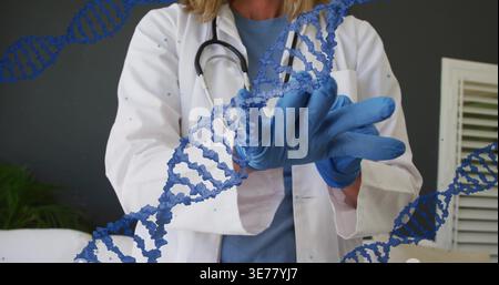 Preparing labcoat-clad physician pulling on blue nitrile gloves in clinic with stethoscope and DNA Stock Photo