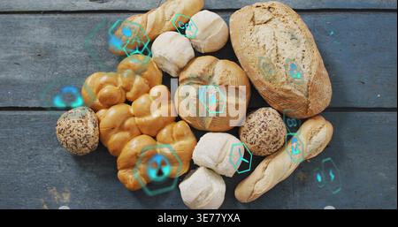 Assorted breads resting on blue-gray plank, teal holos appearing on reveal showing crust for bakery Stock Photo