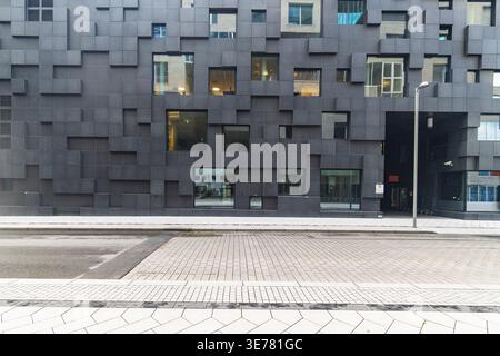 View of a modern building with a geometric facade rising above the street in the heart of Oslo, Norway, showcasing contemporary architecture, Oslo, No Stock Photo
