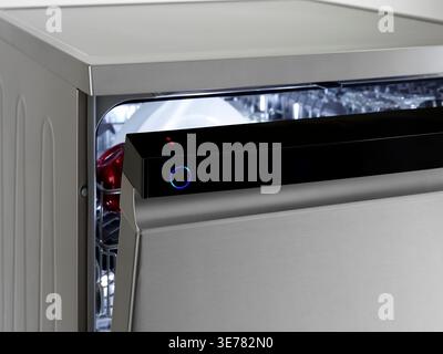 Dishwasher with open door and illuminated control panel, modern and stainless steel Stock Photo
