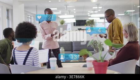 Presenting man holding folder and addressing team in lounge, showing social overlays Stock Photo