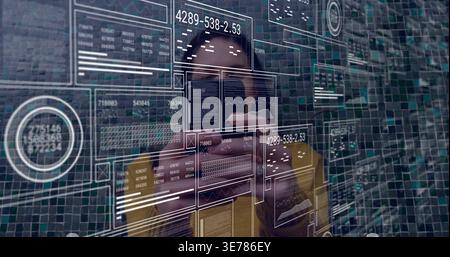 Vertical video: After data ping mid-adult man in yellow coat touching clear UI while analyzing data Stock Photo