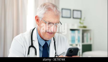 Phone, doctor and texting with man in office of hospital for telehealth advice, medical diagnosis or contact. Healthcare expert, virtual consulting or Stock Photo