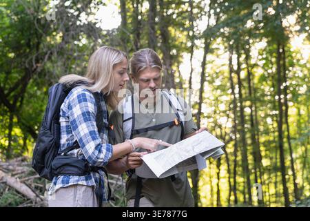 Couple navigating with map to planning hiking adventure together Stock Photo