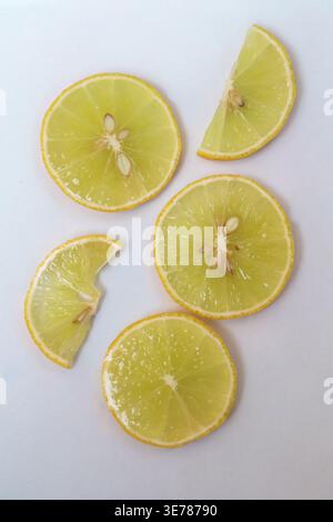 Freshly cut grapefruit slices isolated on a white background, bright pink or red citrus fruit pieces with juicy texture, healthy natural food concept. Stock Photo