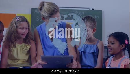 Leading teacher in sleeveless blue guiding five kids in classroom, holding tablet, globe overlay Stock Photo